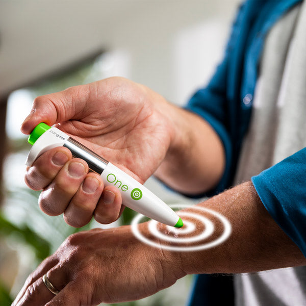 Person using the Paingone One pen on the wrist with pulsating circles to show the electric pulses