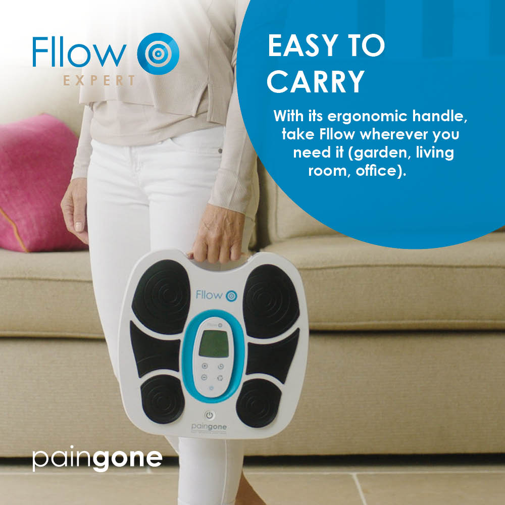 Woman holding the Paingone Fllow device by the ergonomic handle to show how easy to carry it is 